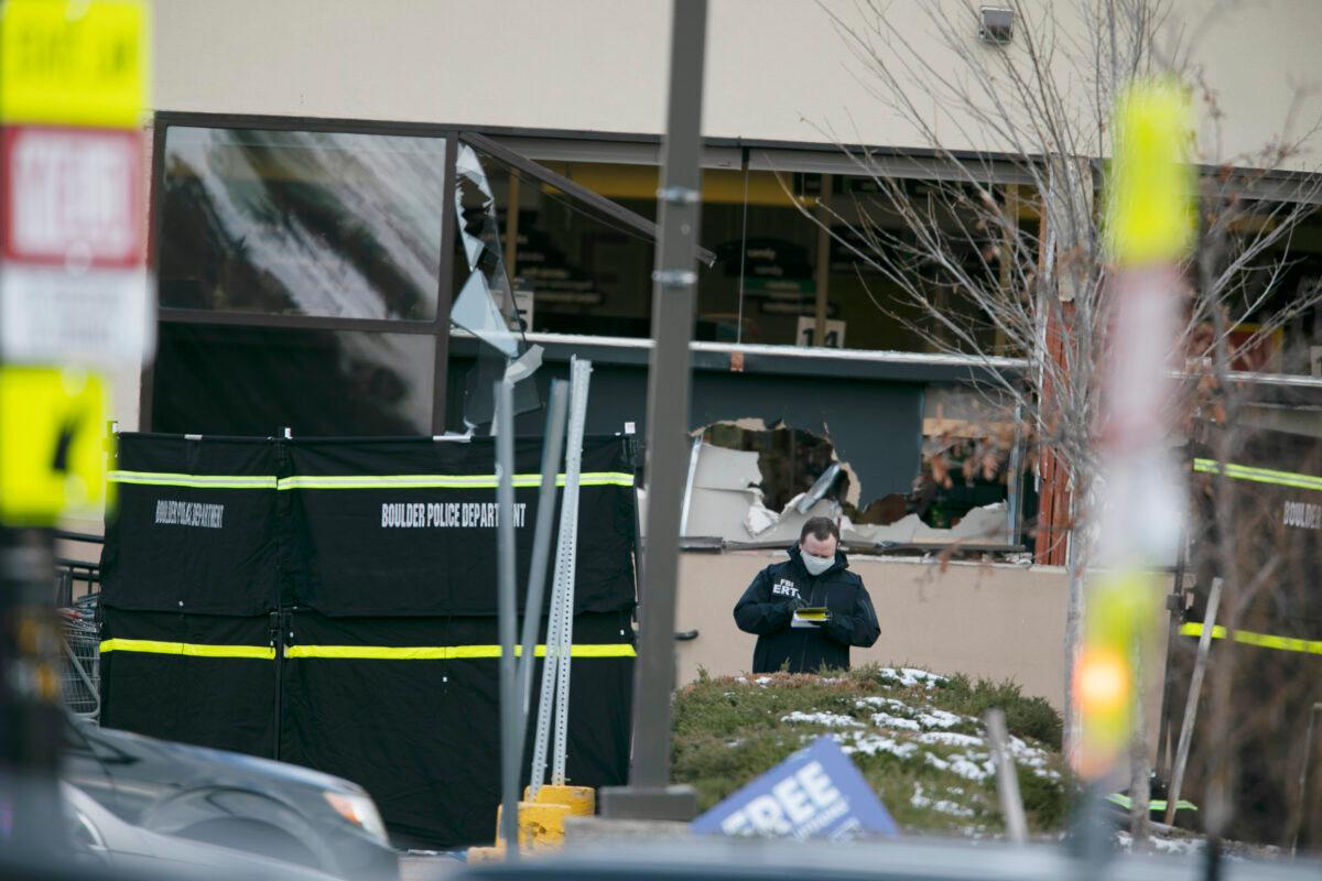 Police work on the scene outside of a King Soopers grocery store where 10 people were killed in a shooting in Boulder, Colo., on March 22, 2021. (Joe Mahoney/AP Photo)