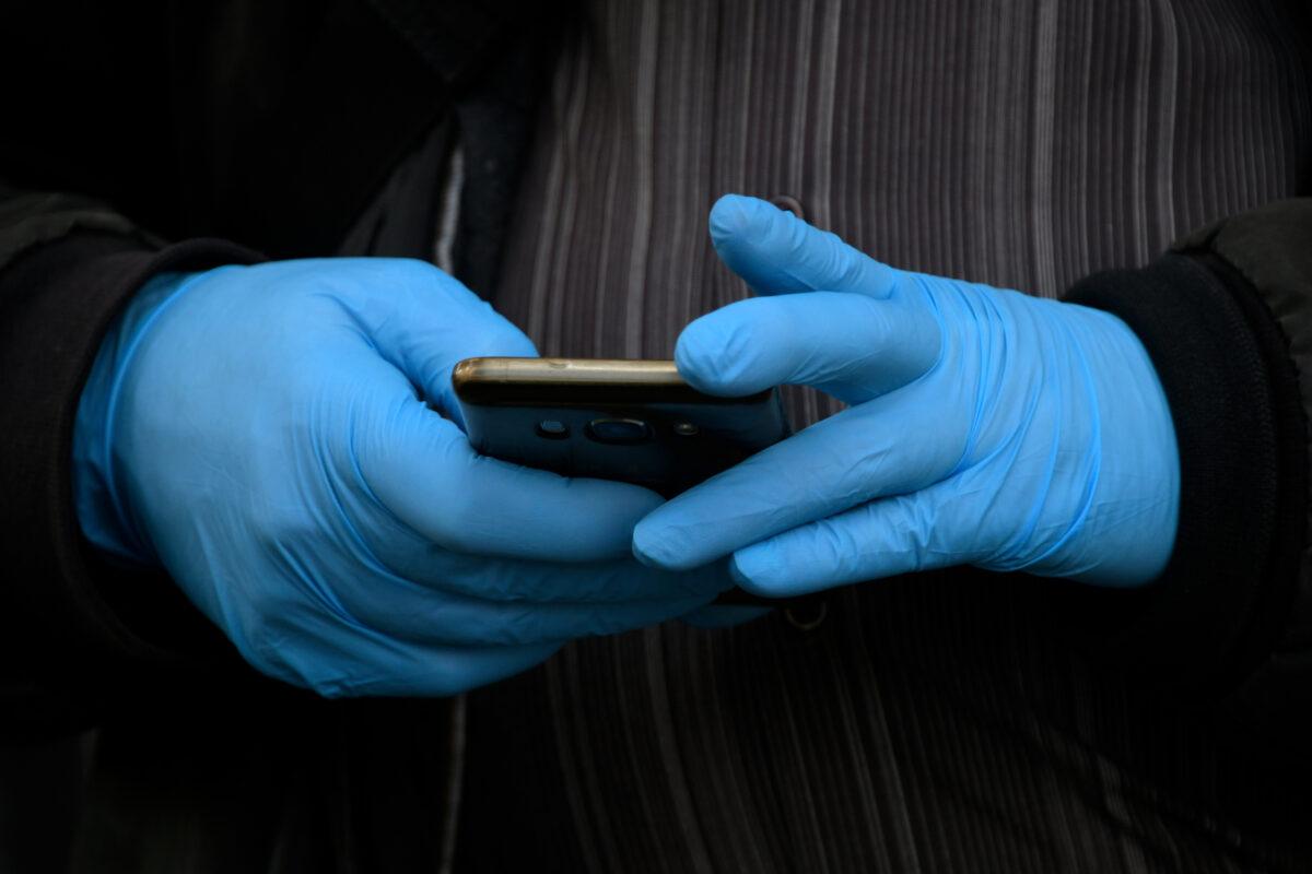 A man holds a smartphone in a file photograph. (Gabriel Bouys/AFP via Getty Images)