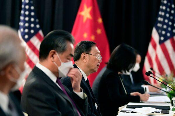 The Chinese delegation led by Yang Jiechi (C), director of the Central Foreign Affairs Commission Office, and Wang Yi (2nd L), China's Foreign Minister, speak with their U.S. counterparts at the opening session of U.S.-China talks at the Captain Cook Hotel in Anchorage, Alaska, on March 18, 2021. (Frederic J. Brown/Pool/AFP via Getty Images)