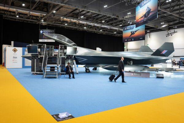 A delegate walks past a model of the BAE Systems Tempest jet fighter on day one of the DSEI arms fair at ExCel in London, on Sept 10, 2019. (Leon Neal/Getty Images)