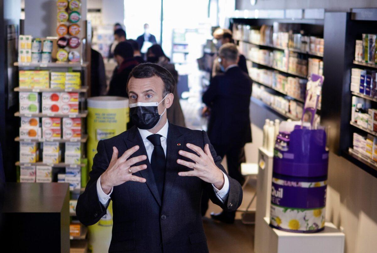 French President Emmanuel Macron talks to the media as he visits a pharmacy in Valenciennes, northern France, on March 23, 2021. (Yoan Valat/Pool Photo via AP)