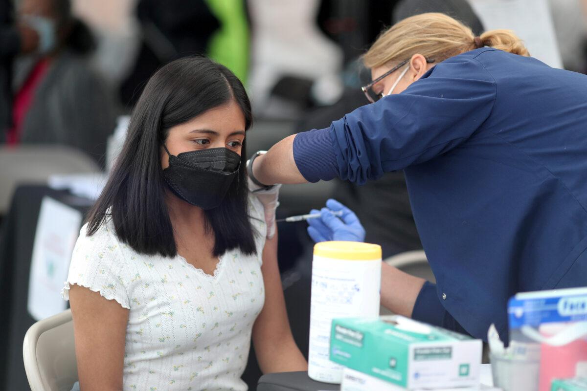 A woman receives a COVID-19 vaccination, at Jordan Downs in Los Angeles, Calif., on March 10, 2021. (Lucy Nicholson/Reuters)