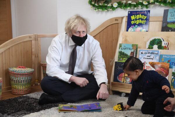 Britain's Prime Minister Boris Johnson visits the Monkey Puzzle Nursery in west London on March 25, 2021. (Jeremy Selwyn/POOL/AFP via Getty Images)