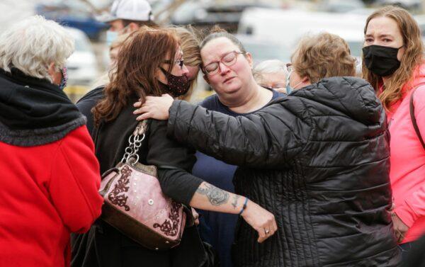 Prison workers comfort each other after a news conference in front of the Anamosa State Penitentiary in Anamosa, Iowa, on March 24, 2021. (Jim Slosiarek/The Gazette via AP)