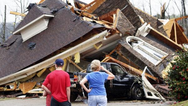 Residents survey damage to homes after a tornado touched down south of Birmingham, Ala. in the Eagle Point community damaging multiple homes on March 25, 2021. (Butch Dill/AP Photo)