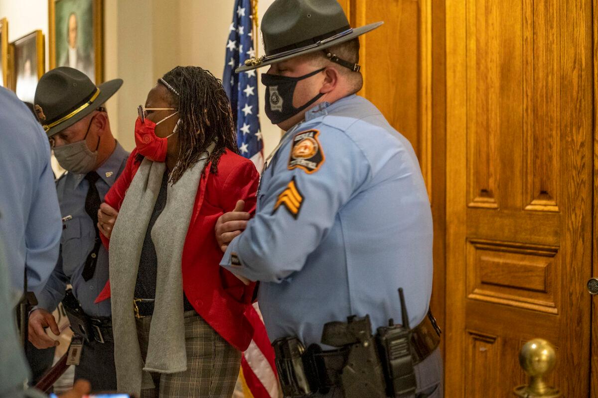 State Rep. Park Cannon (D-Atlanta) is placed in handcuffs by Georgia State Troopers after being asked to stop knocking on a door that lead to Gov. Brian Kemp's office at the Georgia State Capitol Building in Atlanta, Ga., on March 25, 2021. (Alyssa Pointer/Atlanta Journal-Constitution via AP)