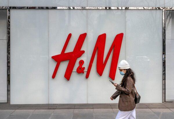 A woman walks by the flagship store of clothing brand H&M at a shopping area in Beijing, China, on March 25, 2021. (Kevin Frayer/Getty Images)