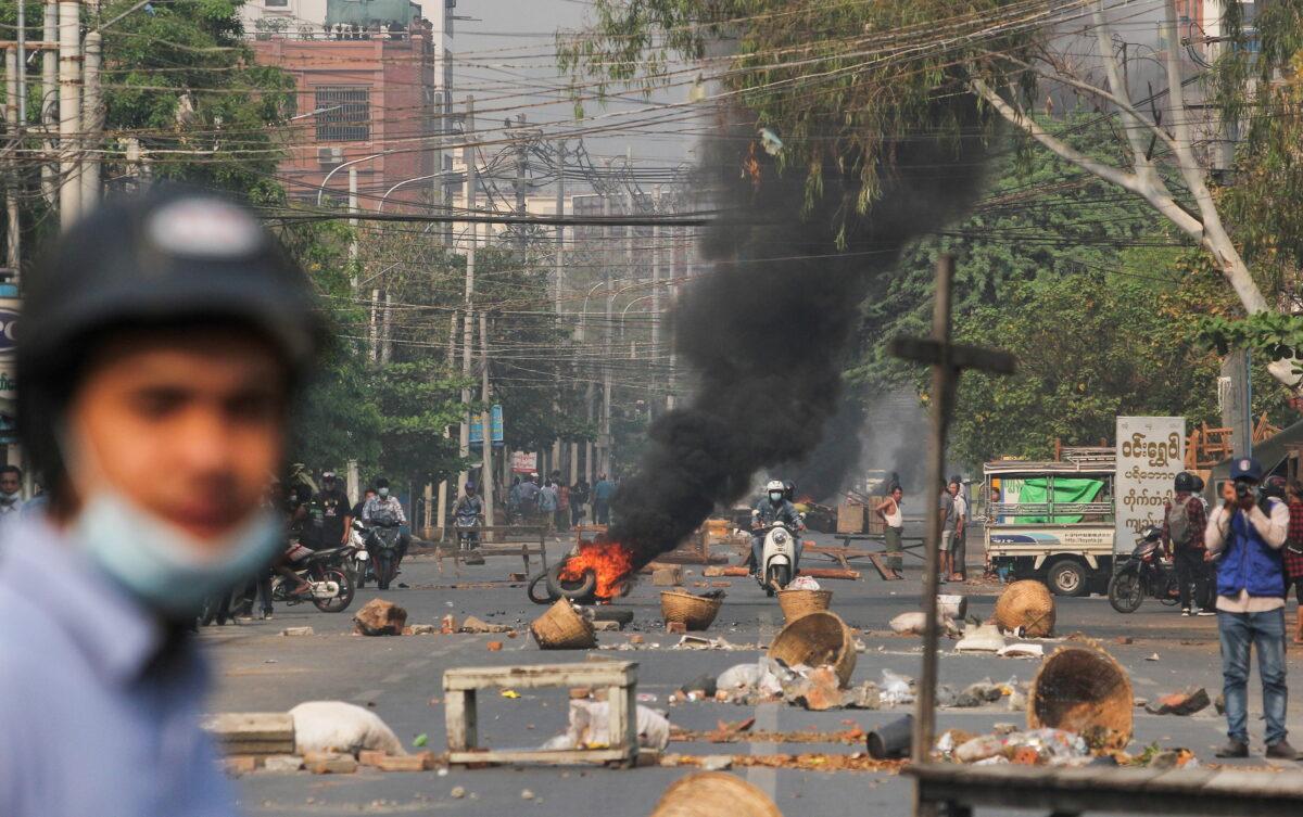 Tires burn on a street as protests against the military coup continue, in Mandalay, Burma, on March 27, 2021. (Stringer/Reuters)