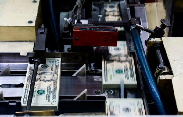 Packs of freshly printed $20 notes are processed for bundling at the U.S. Treasury's Bureau of Engraving and Printing in Washington on July 20, 2018. (Eva Hambach/AFP via Getty Images)