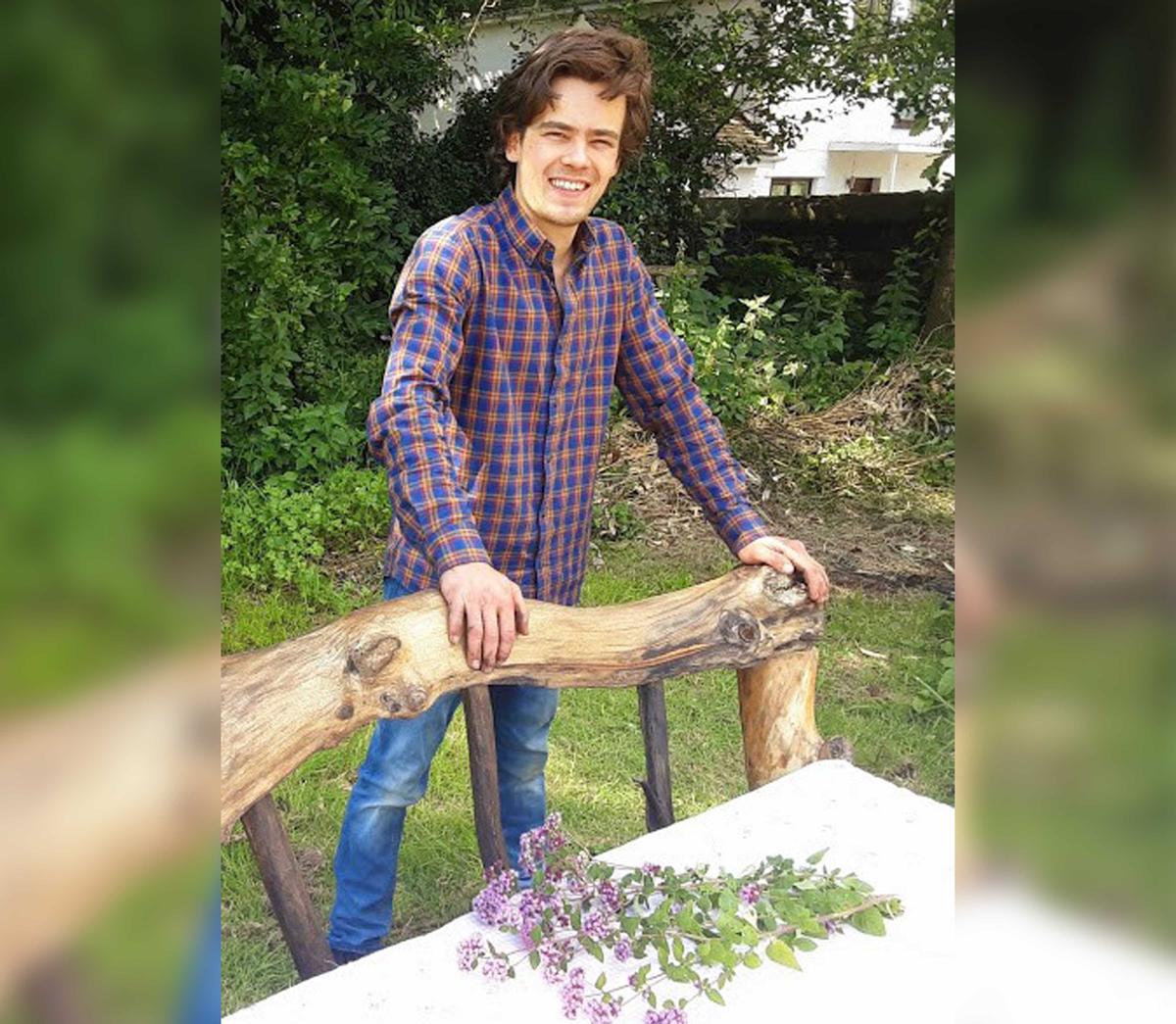 Billy Walden with his rustic new bed made out of driftwood (Caters News)