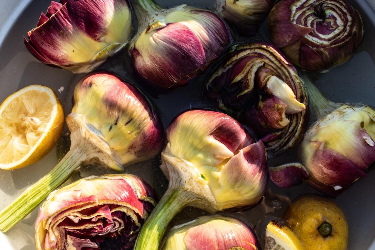Keep your cut and cleaned artichokes in lemon water to prevent them from browning. (Wanderlust Media/shutterstock)