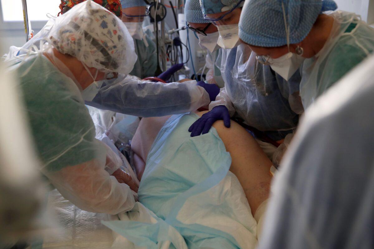 Medical workers tend to a patient affected with the COVID-19 in the Amiens Picardie hospital in Amiens, France, on March 30, 2021. (Francois Mori/AP Photo)