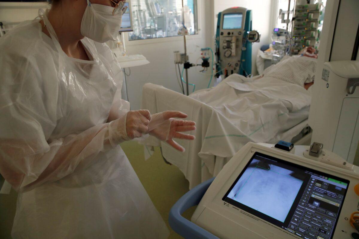 A medical worker checks on a screen a patient's lung affected with the COVID-19 in the Amiens Picardie hospital in Amiens, France, on March 30, 2021. (Francois Mori/AP Photo)