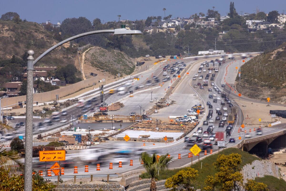 Work crews work on the construction of a freeway overpass in Encinitas, Calif., on March 30, 2021. (Mike Blake/Reuters)
