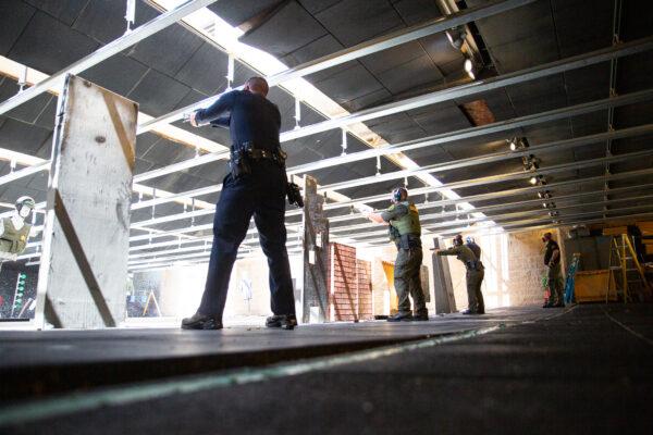 Police officers fire weapons downrange at the Orange County Sheriff's Department shooting range in Orange, Calif., on March 30, 2021. (John Fredricks/The Epoch Times)