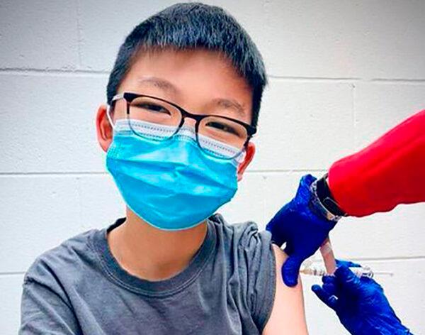 Caleb Chung receives the first dose of Pfizer CCP virus vaccine or placebo as a trial participant for kids ages 12-15, at Duke University Health System in Durham, N.C., on Dec. 22, 2020. (Richard Chung via AP)