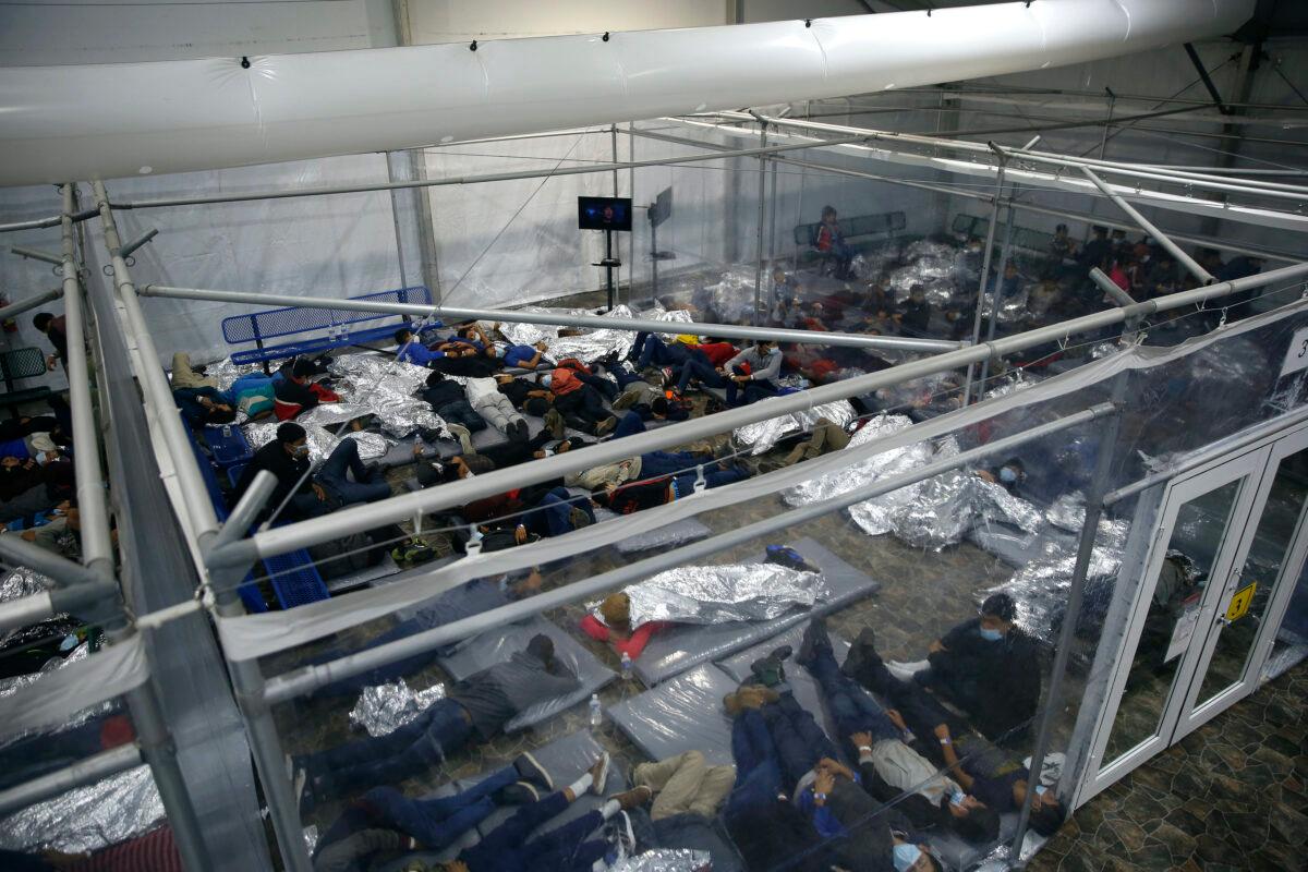 Young minors lie inside a pod at the Donna Department of Homeland Security holding facility, the main detention center for unaccompanied children in the Rio Grande Valley run by the U.S. Customs and Border Protection (CBP), in Donna, Texas, on March 30, 2021. (Dario Lopez-Mills/Pool/AP Photo)