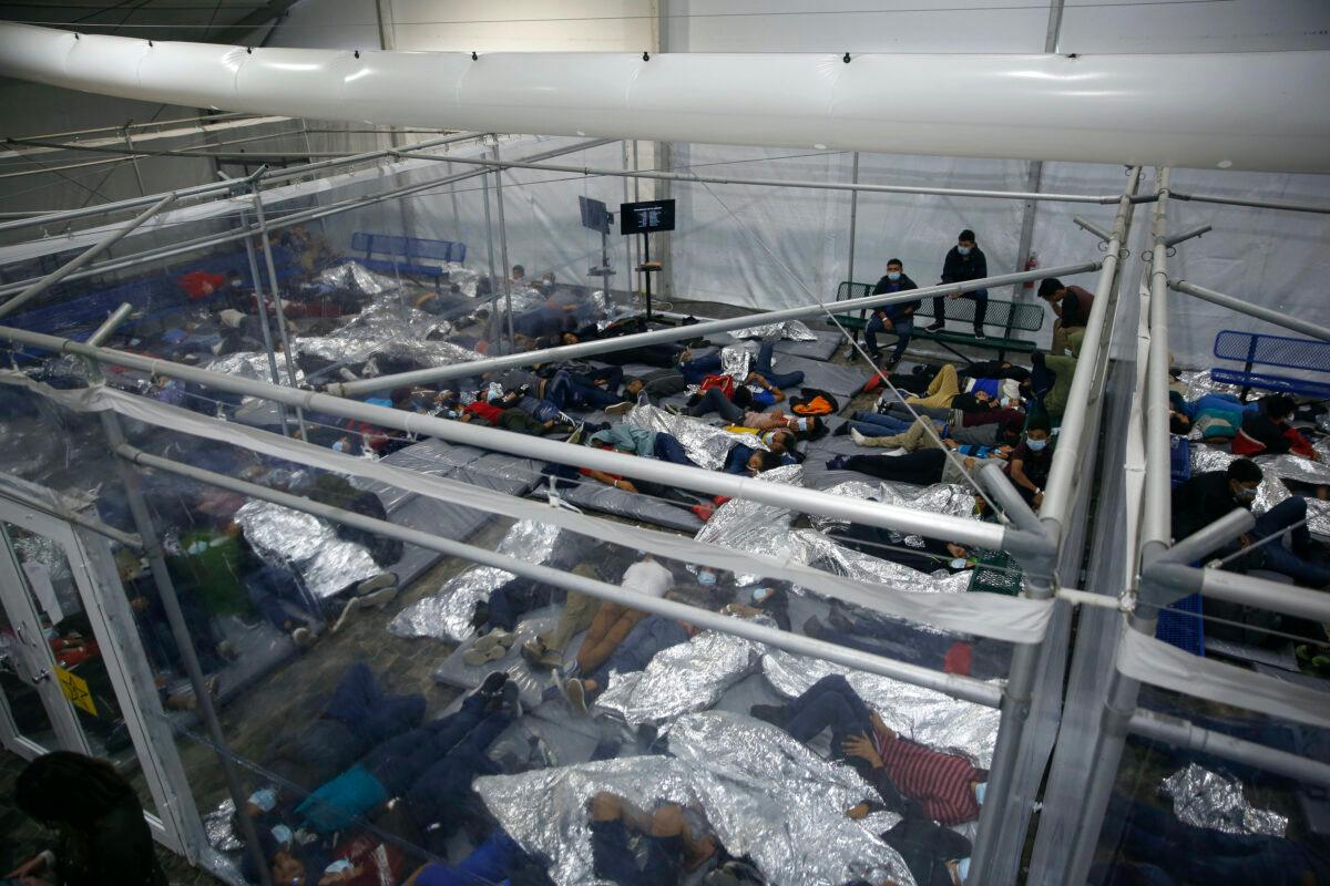 Unaccompanied minors lie inside a pod at a holding facility in Donna, Texas, on March 30, 2021. (Dario Lopez-Mills/AP Photo/Pool)