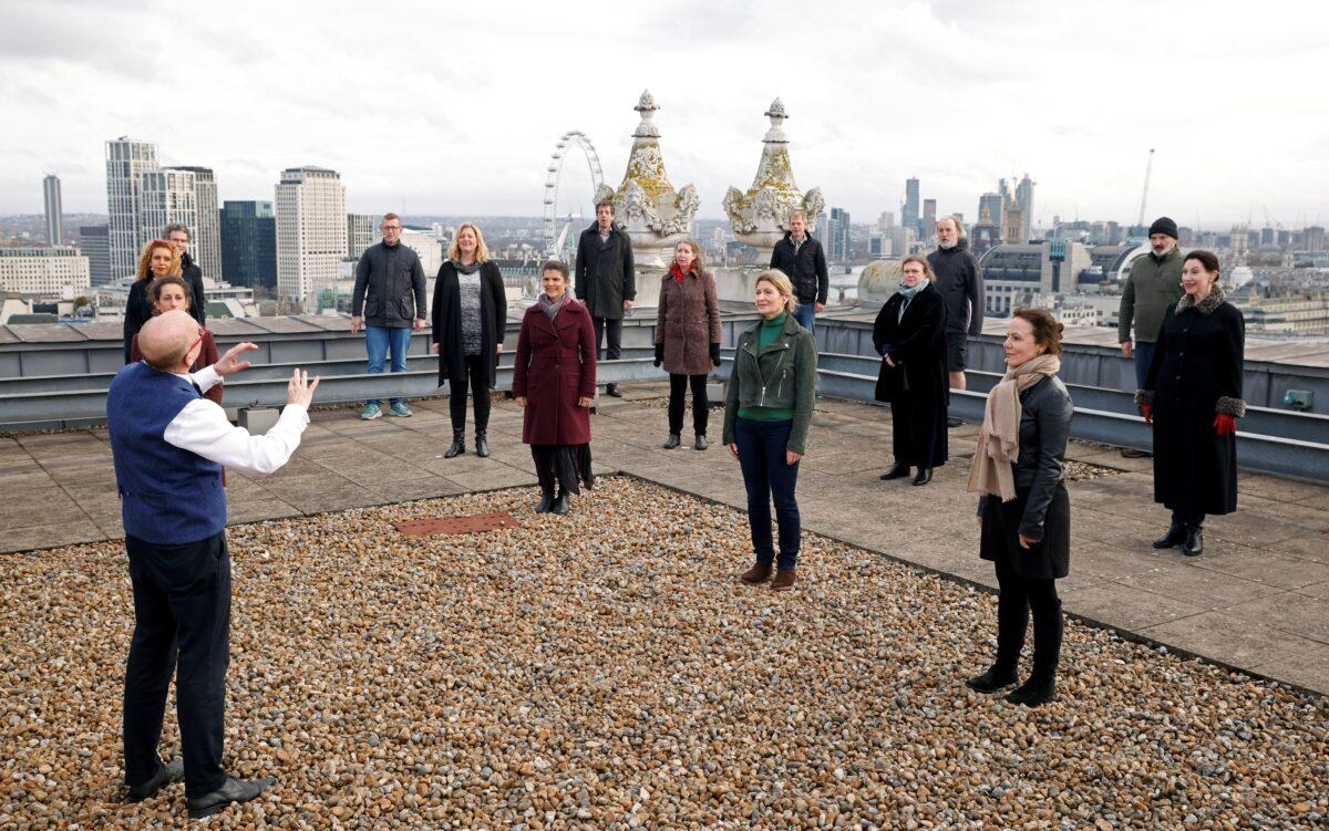 The choir of London's Royal Opera House perform on the rooftop of the Royal Opera House to celebrate Good Friday and the arrival of spring in London, Britain, on March 25, 2021. (John Sibley/Reuters)