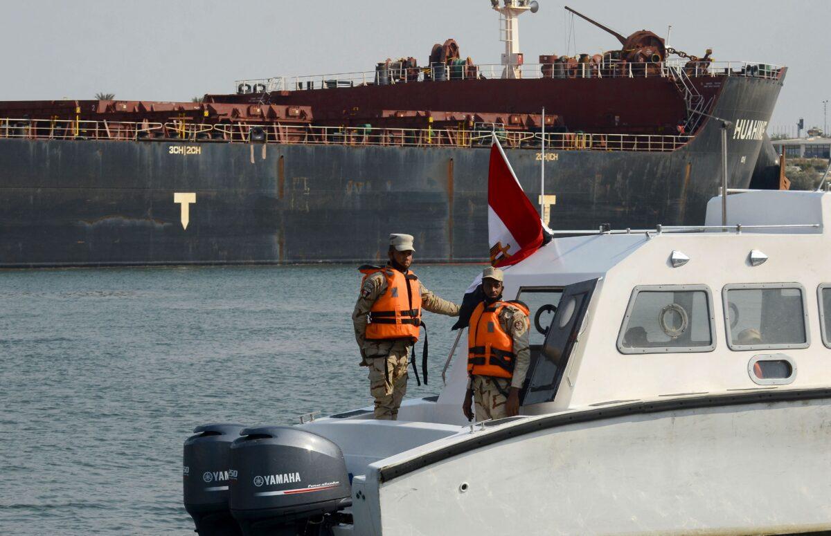 Egyptian coast guards patrol as a ship navigates the Suez Canal, on March 30, 2021. (Tarek Wajeh/AFP via Getty Images)