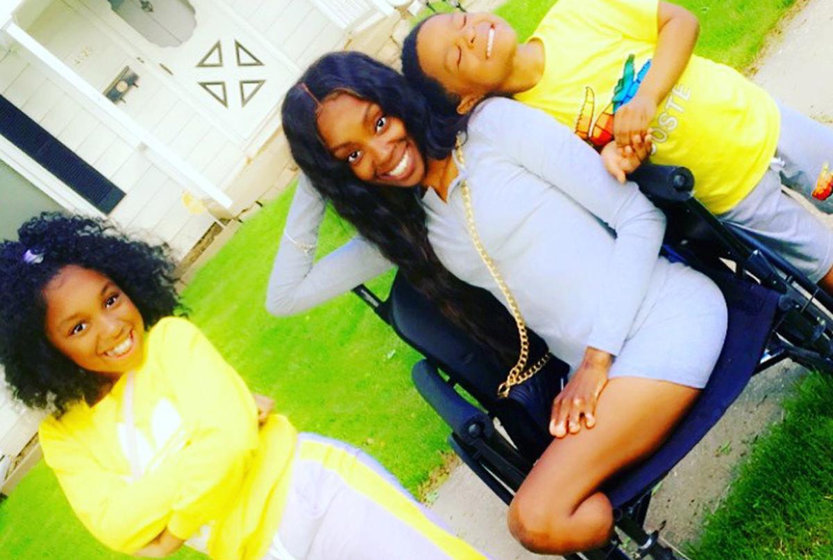 Kia in a wheelchair with her kids, Madyson and King (Caters News)