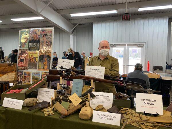 Andy Galusha, a landscape architect in Fairfax County, showcased World War I historical records and weapons at a gun show in Manassas, Va., on March 28, 2021. (Terri Wu/The Epoch Times)