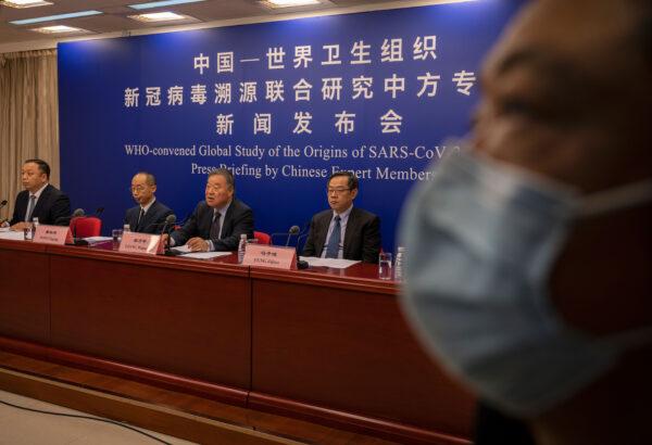 Head of the Expert Group on COVID Response at China's National Health Commission, Liang Wannian, center, answers a question as he sits with colleagues Feng Zijian, right, and Tong Yigan, second left, at a press conference addressing the World Health Organization (WHO) report on the origins of SARS-CoV-2, at the National Health Committee in Beijing, on March 31, 2021. (Kevin Frayer/Getty Images)