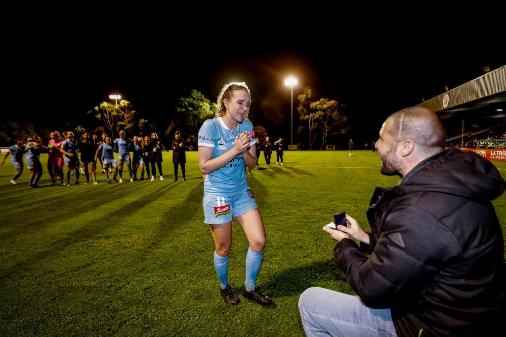 Matt Stonham proposing to Rhali Dobson after her final match at Frank Holohan Reserve in Melbourne, Australia, on March 25, 2021. (Darrian Traynor/Getty Images)