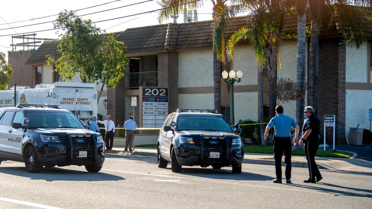 Officials work outside the scene of a shooting, in Orange, Calif., on April 1, 2021. (Paul Bersebach/The Orange County Register via AP)
