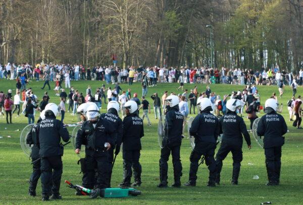 Belgian police forces disperse young people gathering at the Bois de la Cambre/Ter Kamerenbos park for a party in defiance of Belgium's CCP virus social distancing measures and restrictions, in Brussels on April 1, 2021. (Clement Rossignol/Reuters)