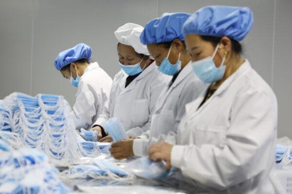 Workers making medical masks at a factory in Jishou, Hunan Province, China, on Jan. 28, 2021. (Photo by STR / AFP) / China OUT (Photo by STR/AFP via Getty Images)