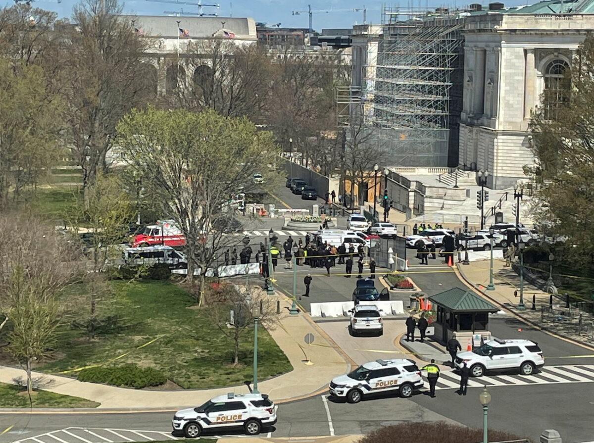 U.S. Capitol police surround a blue car that rammed a police barricade outside the U.S. Capitol building on Capitol Hill in Washington on April 2, 2021. (Michael Weekes/Reuters)