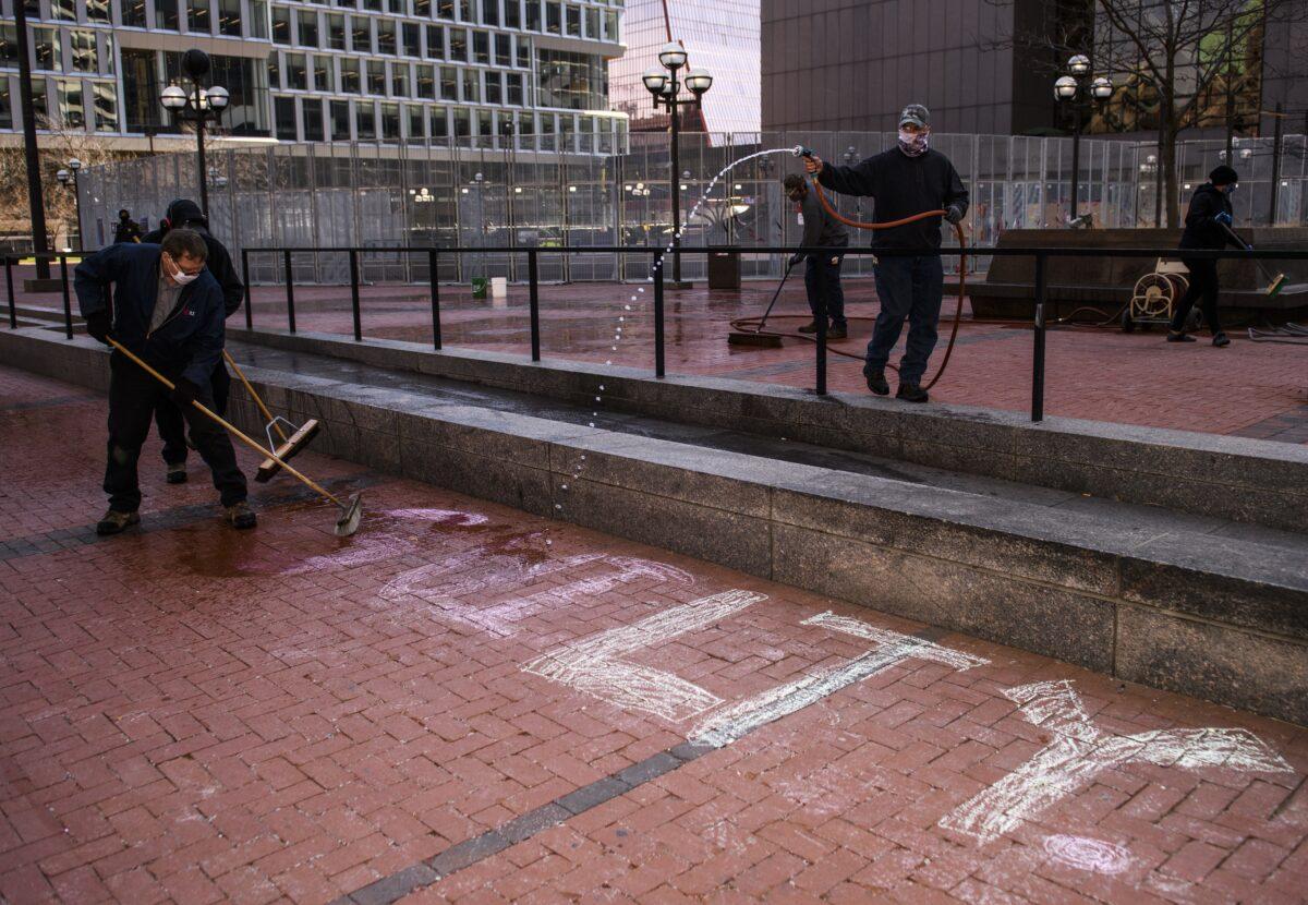 Crews remove artwork from the plaza outside the Hennepin County Government Center in Minneapolis, as the trial of former police officer Derek Chauvin continues inside, on April 2, 2021. (Stephen Maturen/Getty Images)