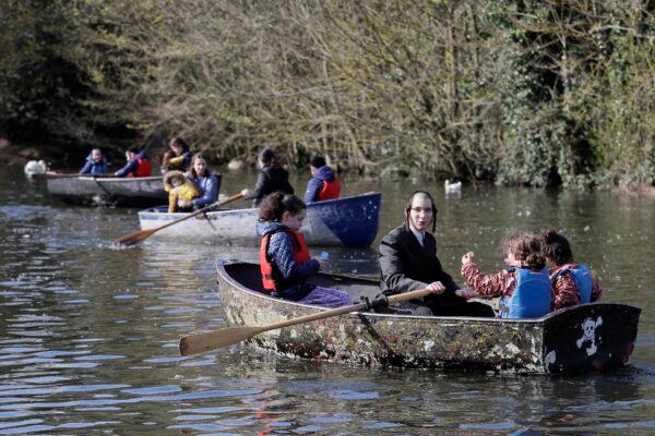 Families enjoy a boating lake in Finsbury Park as lockdown measures start to be relaxed in London, on April 2, 2021. (Kirsty Wigglesworth/AP Photo)