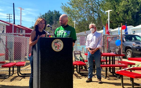 Entertainment reporter Lisa Joyner (L) and actor Jon Cryer (C) address the crowd from the podium while Councilman Paul Krekorian (R) watches at the North Hollywood Tiny Home Village in Los Angeles on March 24, 2021. (Jamie Joseph/The Epoch Times)