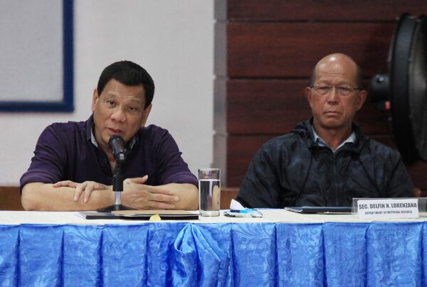 Philippine President Rodrigo Duterte (L) speaks in a meeting with local officials as Defence Secretary Delfin Lorenzana (R) looks on during a visit to Legazpi City, Albay Province, Philippine on Jan. 29, 2018. (-/AFP via Getty Images)