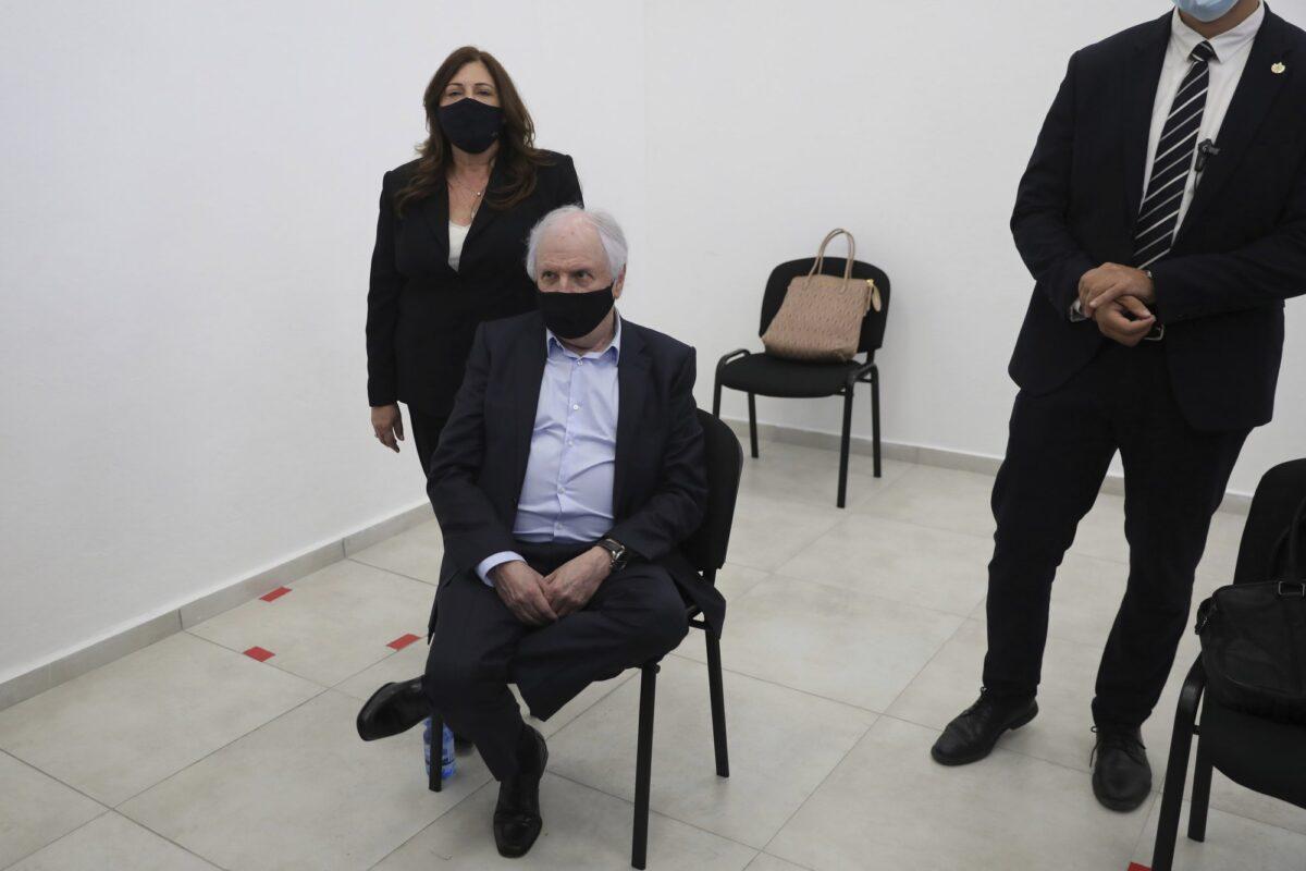 Israeli businessman Shaul Elovitch and his wife Iris attend the hearing for Prime Minister Benjamin Netanyahu's trial over alleged corruption crime in Jerusalem on April 5, 2021. (Abir Sultan/AP)