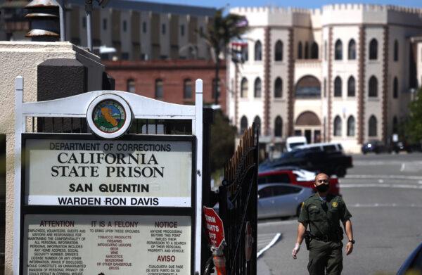A California Department of Corrections and Rehabilitation (CDCR) officer stands guard at the front gate of San Quentin State Prison in San Quentin, Calif., on June 29, 2020. (Justin Sullivan/Getty Images)