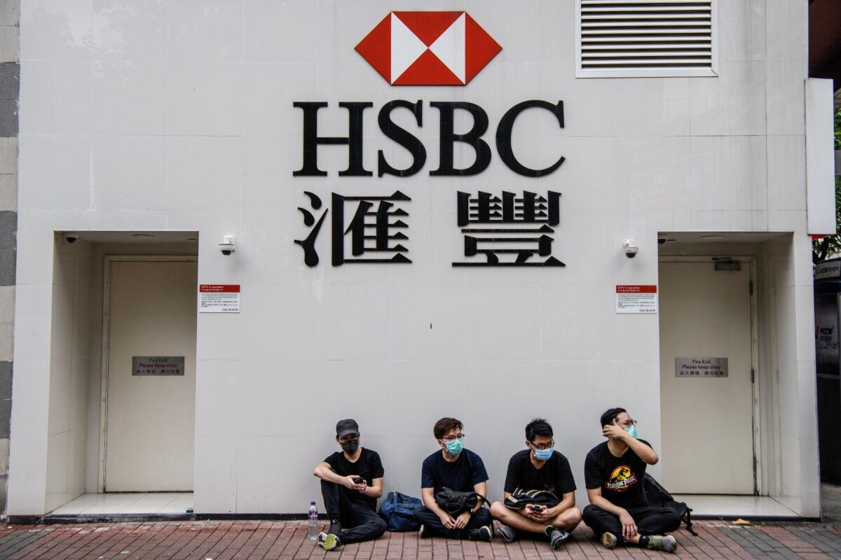 Pro-democracy protesters sit outside HSBC in the Kowloon district of Hong Kong on Aug. 11, 2019. (Anthony Wallace/AFP via Getty Images)