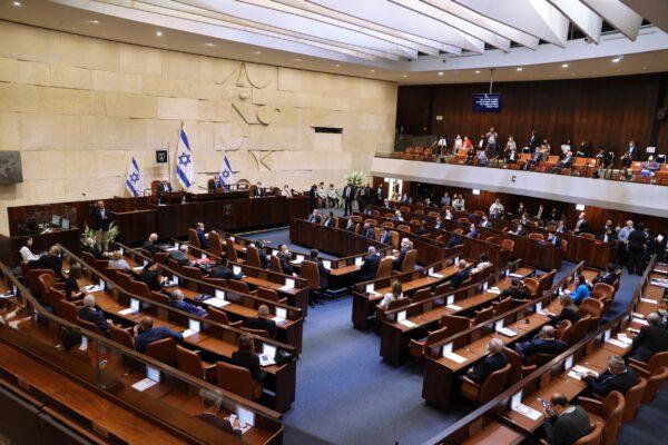 Israeli lawmakers attend the swearing-in ceremony for Israel's 24th government, at the Knesset, or parliament, in Jerusalem, Israel, on April 6, 2021. (Alex Kolomoisky/Pool via AP)