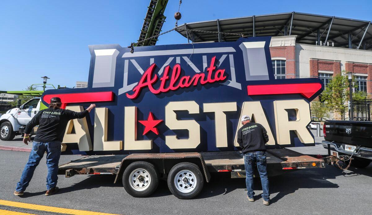 Workers load an All-Star sign onto a trailer after it was removed from Truist Park in Atlanta, Ga., on April 6, 2021. (John Spink/Atlanta Journal-Constitution via AP)