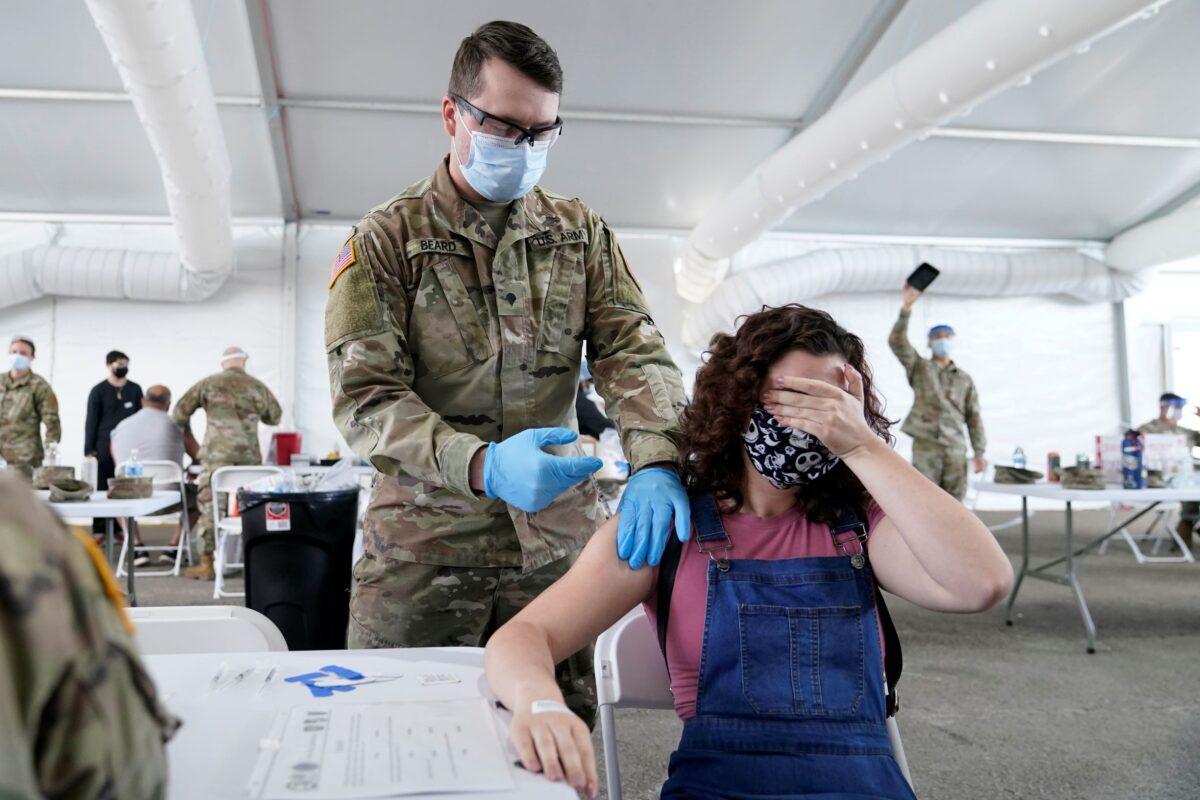 People receive the Pfizer COVID-19 vaccine at a FEMA vaccination center at Miami Dade College in Miami, Fla., on April 5, 2021. (Lynne Sladky/AP Photo)