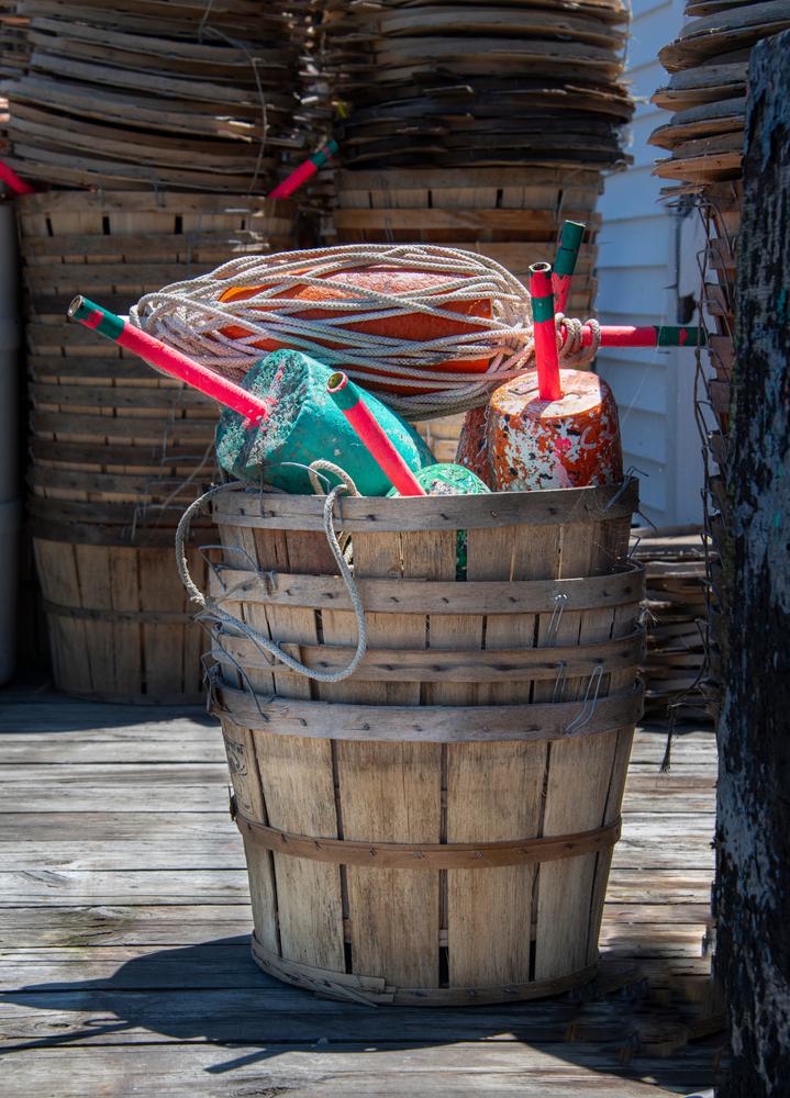 A bucket holds colorful markers that can be used to indicate the underwater location of crab traps. (Leslie Billman/Shutterstock)