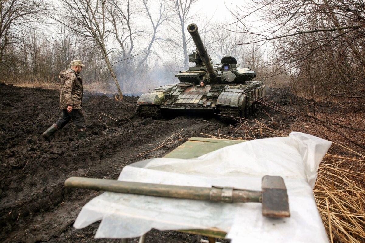 Ukrainian servicemen work on their tank close to the front line with Russian-backed separatists near Lysychansk, Ukraine, on April 7, 2021. (STR/AFP via Getty Images)