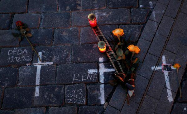 Candles and flowers are placed to pay respect to victims of the COVID-19 pandemic at a spontaneous memorial place set at the Old Town Square in Prague, Czech Republic, on March 29, 2021. (Petr David Josek/AP Photo)