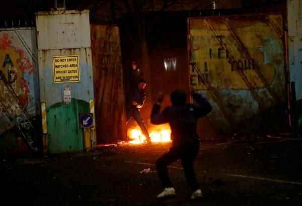 Protesters at the "peace wall" gate into Lanark Way as protests continue in Belfast, Northern Ireland, on April 7, 2021. (Jason Cairnduff/Reuters)