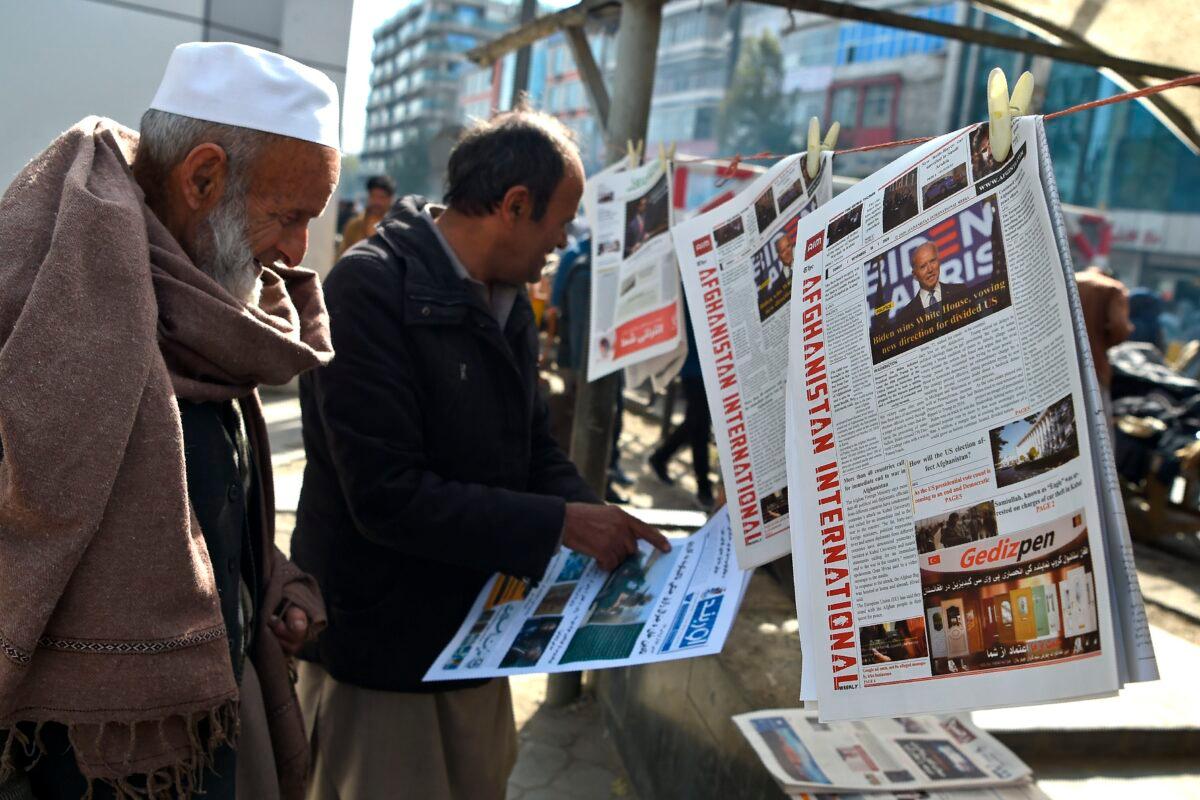 A man reads a local newspaper showing a photograph of newly elected U.S. President Joe Biden, in Kabul on Nov. 8, 2020. (Wakil Kohsar/AFP via Getty Images)