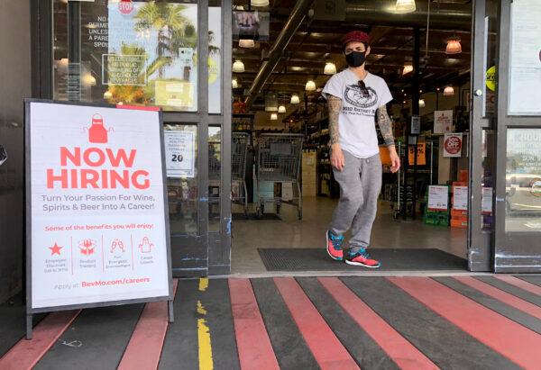 A customer walks by a now hiring sign at a BevMo store in Larkspur, Calif., on April 2, 2021. (Justin Sullivan/Getty Images)