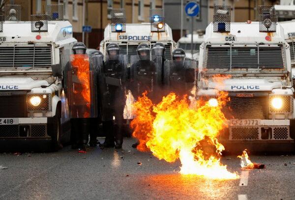 A fire burns in front of the police on the Springfield Road as protests continue in Belfast, Northern Ireland, on April 8, 2021. (Jason Cairnduff/Reuters)