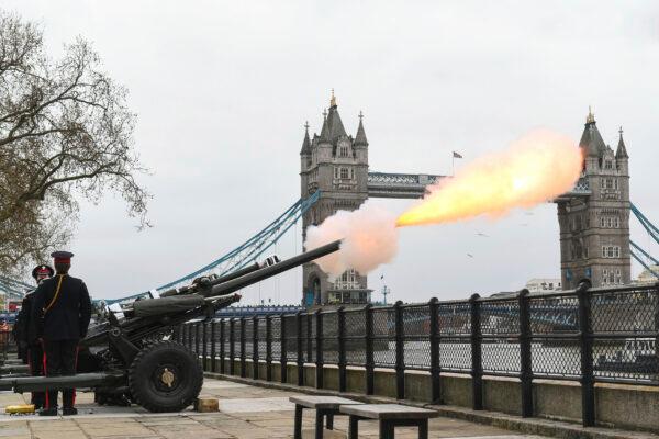 Members of the Honourable Artillery Company fire a 41-round gun salute from the wharf at the Tower of London, to mark the death of Prince Philip, in London, on Apr. 10, 2021. (Dominic Lipinski/PA via AP)